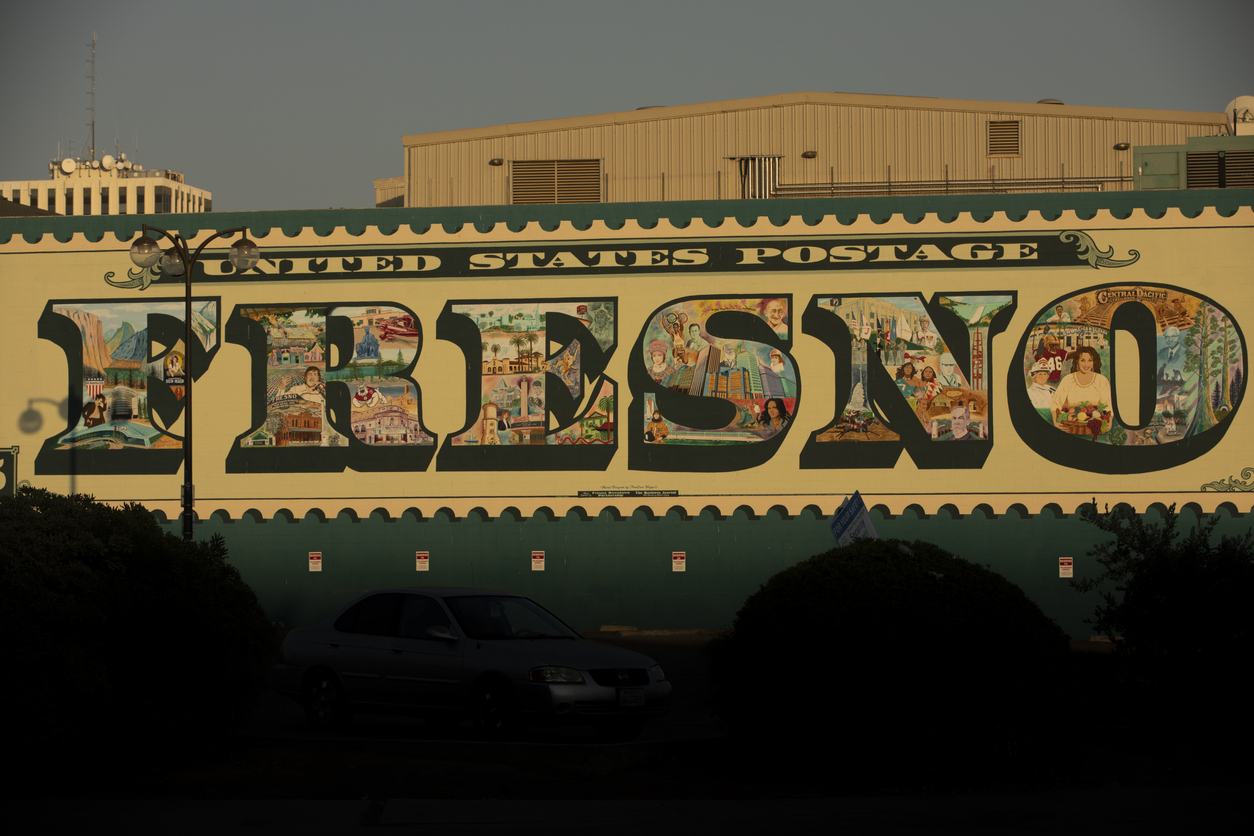 Fresno, California, USA - July 15, 2021: Late afternoon light illuminates a historic downtown Fresno sign.