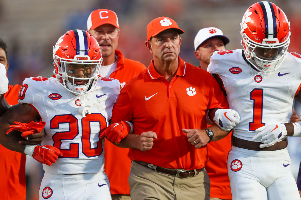 DURHAM, NC - SEPTEMBER 04:Head Coach Dabo Swinney of the Clemson Tigers walks arm in arm with his players before a football game against the Duke Blue Devils at Wallace Wade Stadium in Durham, North Carolina on Sep 4, 2023.